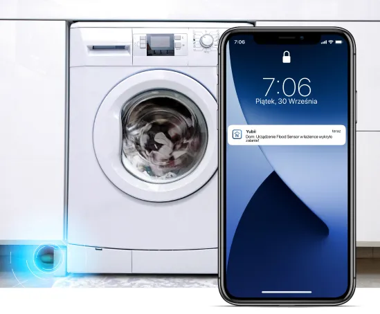 Telefon komórkowy na tle pralki