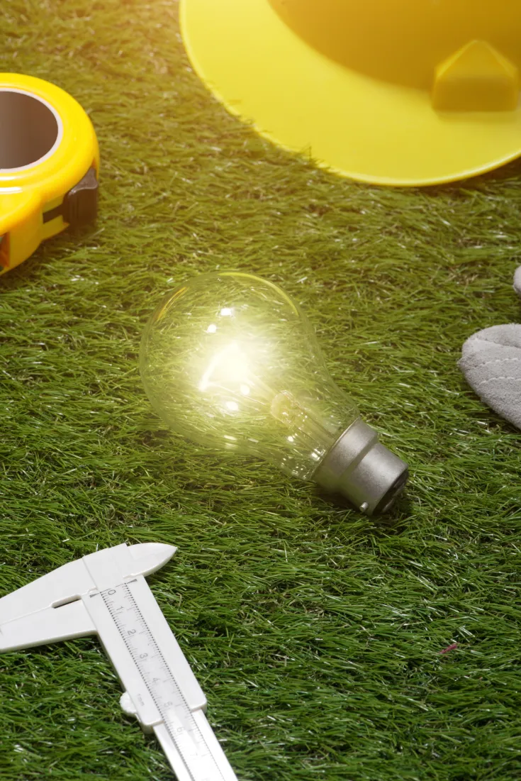 house-engineer-architect-ideas-concept-with-light-bulb-yellow-hat-tools-green-grass